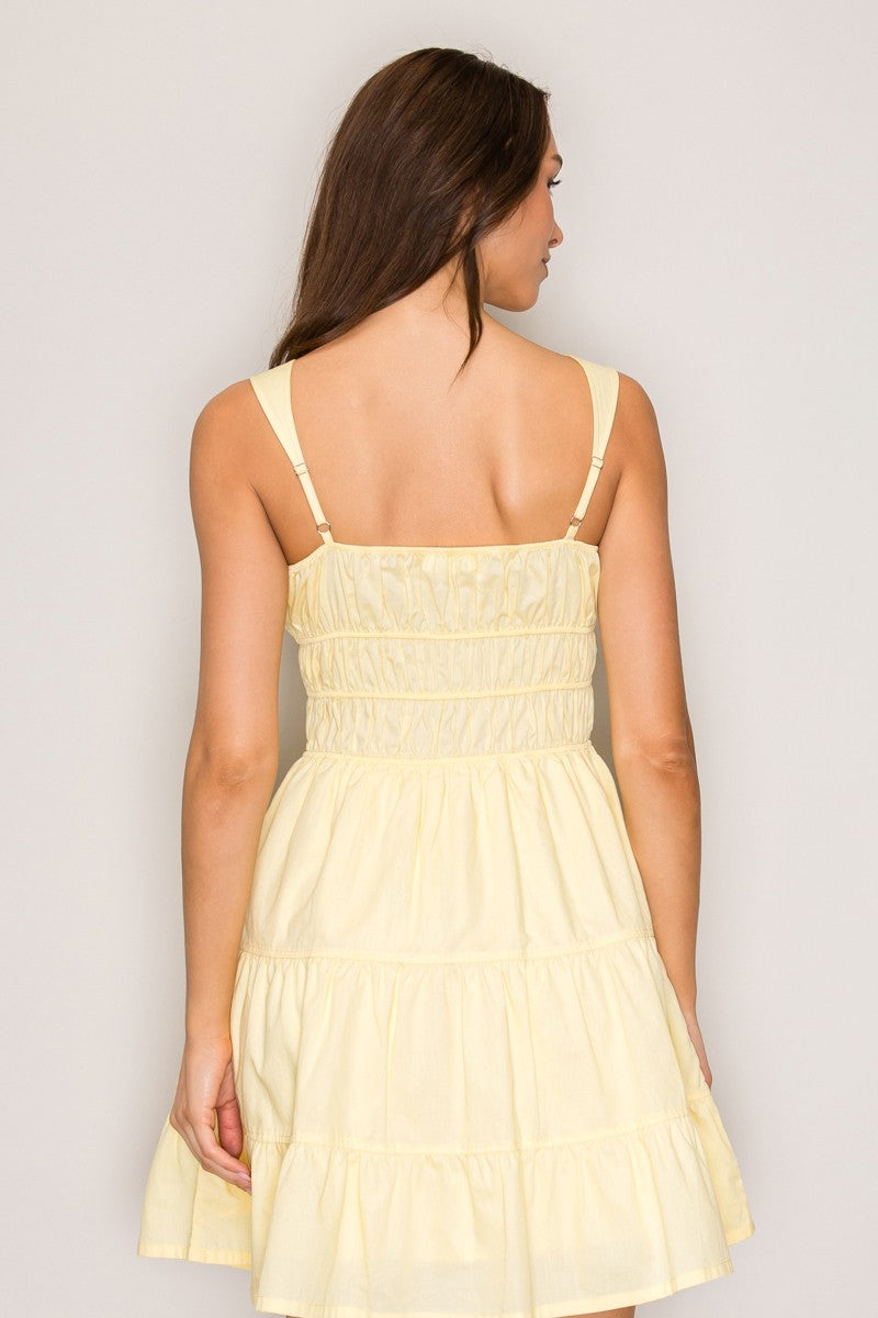 Butter yellow square-neck tie-front smocked-waist tiered mini dress - back view showing adjustable straps and smocked waistband