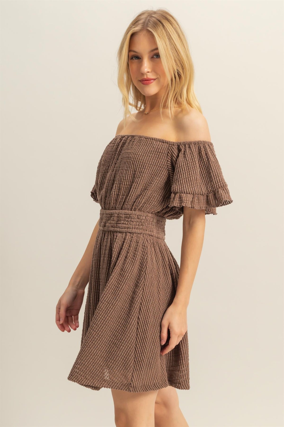 Red textured off-shoulder ruffle-sleeve smocked-waist fit-and-flare mini dress - close-up front detail showing off-shoulder neckline, ruffle, and smocked waistband