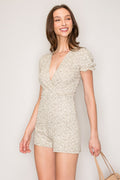 Sage green ditsy-floral deep-V surplice puff-sleeve lettuce-edge smocked-waist short romper - front full view showing surplice neckline and puff sleeves