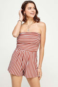 Rust multi-stripe strapless tube-bodice side-pocket short romper - front three-quarter lifestyle view showing full silhouette and stripe detail