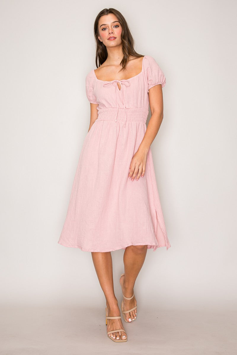 Blush pink crinkle-woven sweetheart-neck front-tie puff-sleeve smocked-waist fit-and-flare midi dress - front full view showing sweetheart neckline and tie bow detail