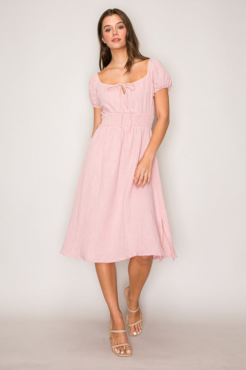 Blush pink crinkle-woven sweetheart-neck front-tie puff-sleeve smocked-waist fit-and-flare midi dress - front full view showing sweetheart neckline and tie bow detail