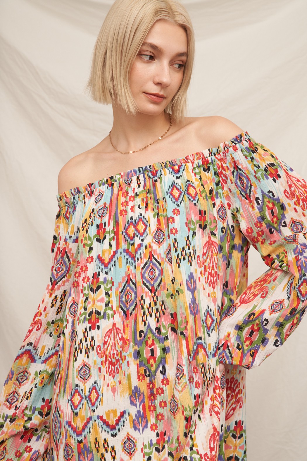 Multicolour ikat print off-shoulder long bishop-sleeve babydoll mini dress - close-up front view showing ikat print detail and neckline frill