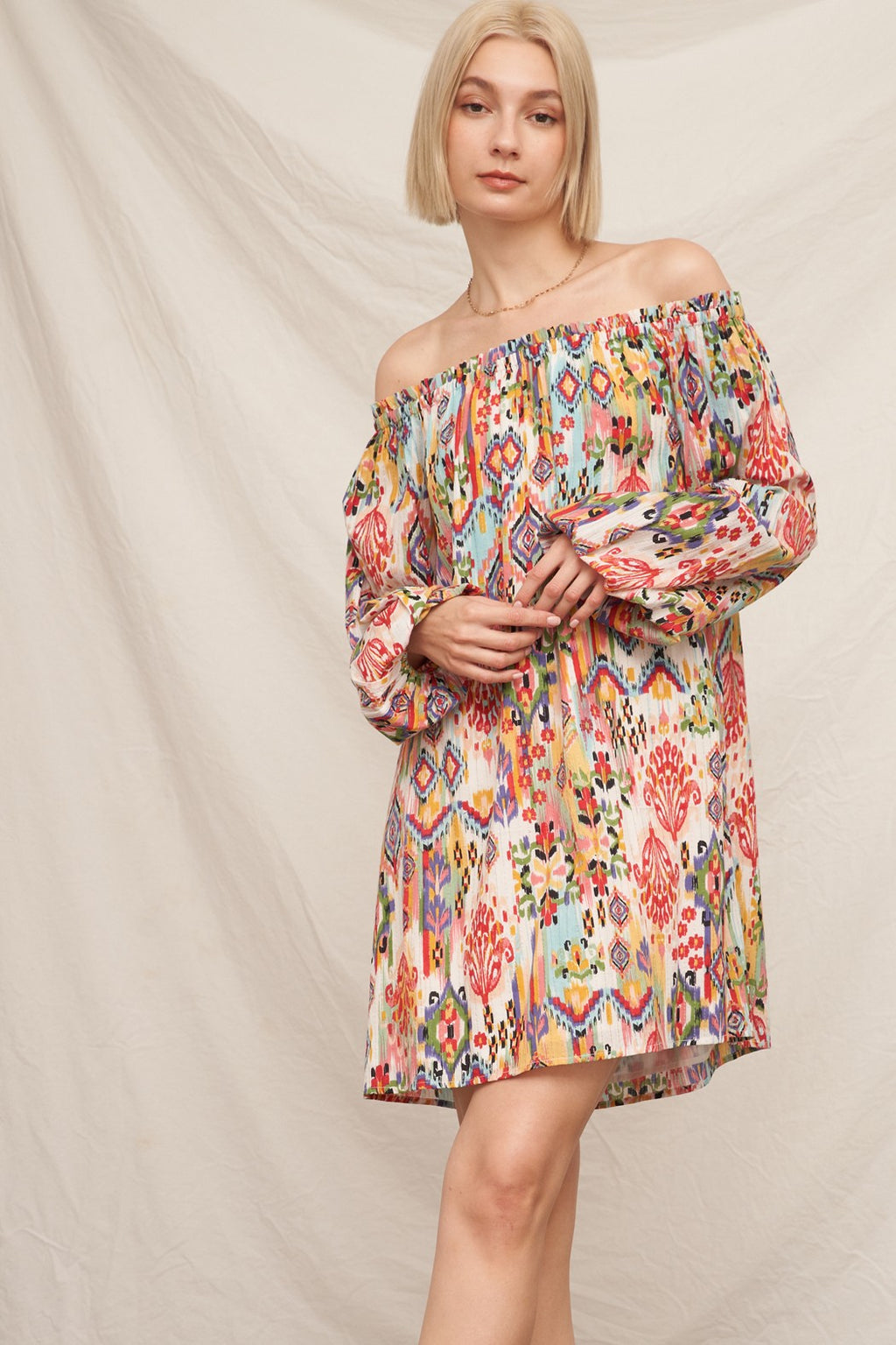 Multicolour ikat print off-shoulder long bishop-sleeve babydoll mini dress - front full view showing off-shoulder neckline and flowing silhouette