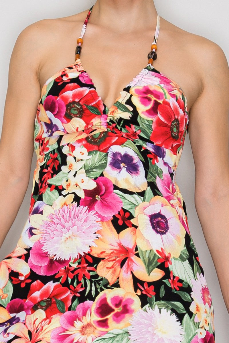 Tropical floral beaded-halter deep-V ruched-bust open-cross-back tiered midi dress - close-up bodice detail showing beaded halter straps, deep-V neckline, ruched bust panel, and bold large-scale tropical floral print on black ground colourway