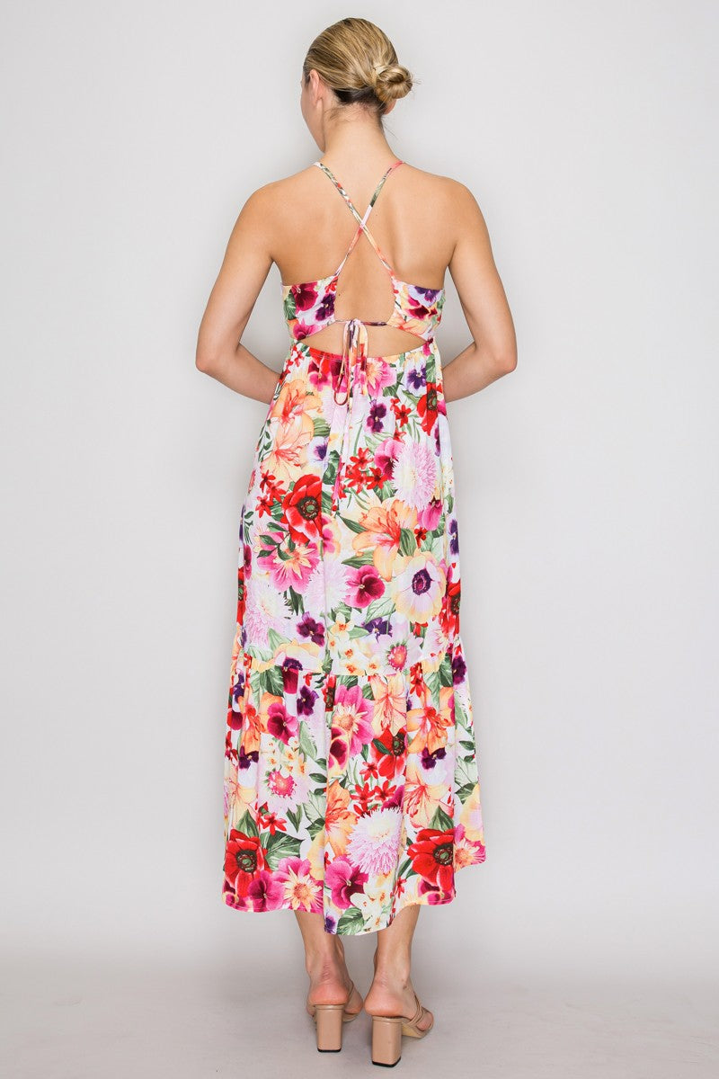 Tropical floral beaded-halter deep-V ruched-bust open-cross-back tiered midi dress - back full-length view showing beaded halter straps, open bare back, diagonal cross-straps at centre back, small back tie, and fluid tiered midi skirt from behind in white-ground tropical floral