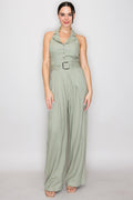 Blush pink halter-collar button-front belted wide-leg jumpsuit - front full view showing open shirt collar, halter neck tie, centre-front metallic buttons, square-buckle belt at waist, and wide-leg trouser silhouette in blush pink
