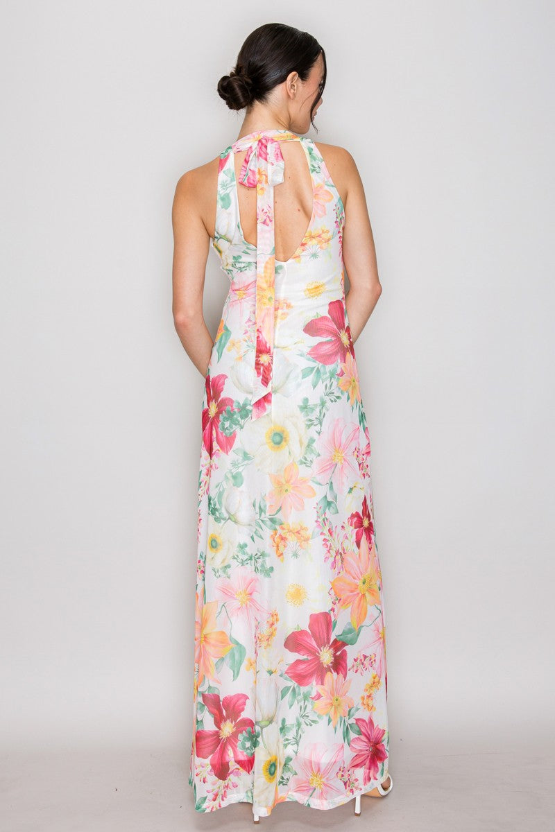 Coral pink watercolour floral print mesh V-neck halter-tie-back maxi dress - side three-quarter view showing deep V-neckline, halter strap construction, fluid A-line maxi silhouette, and large-scale coral pink watercolour floral print on white