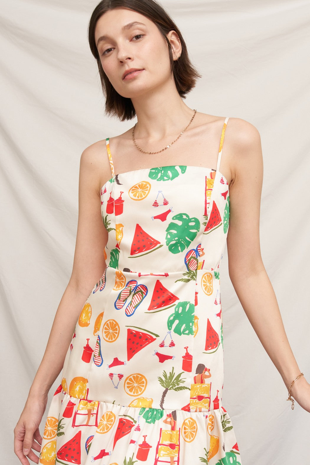 Tropical beach novelty-print spaghetti-strap square-neck fitted-bodice tiered-ruffle-hem mini dress - back view showing square back neckline, spaghetti straps, and tiered ruffle skirt from behind