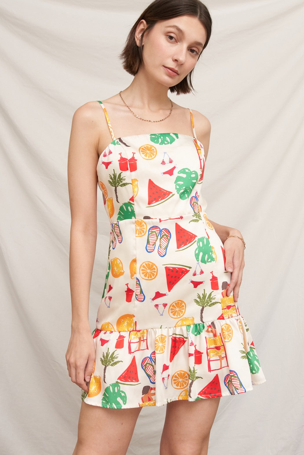 Tropical beach novelty-print spaghetti-strap square-neck fitted-bodice tiered-ruffle-hem mini dress - second front view showing fitted bodice, bold beach print, and ruffle hem at mini length