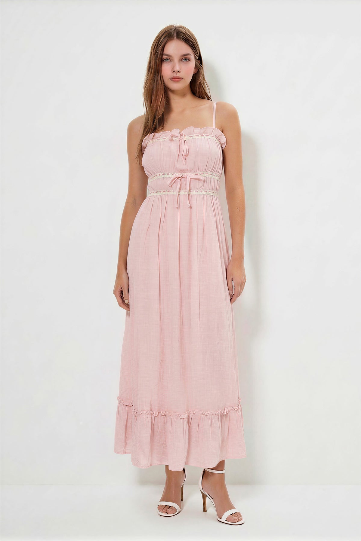 Blush spaghetti-strap ruffle-neckline crochet-lace-trim tie-front gathered-bodice ruffle-hem midi dress - front full-length view showing fine spaghetti straps, softly ruffled neckline with crochet lace trim and centre bow, gathered bodice, crochet lace waistband with bow, pleated skirt, and ruffle hem in soft dusty blush pink