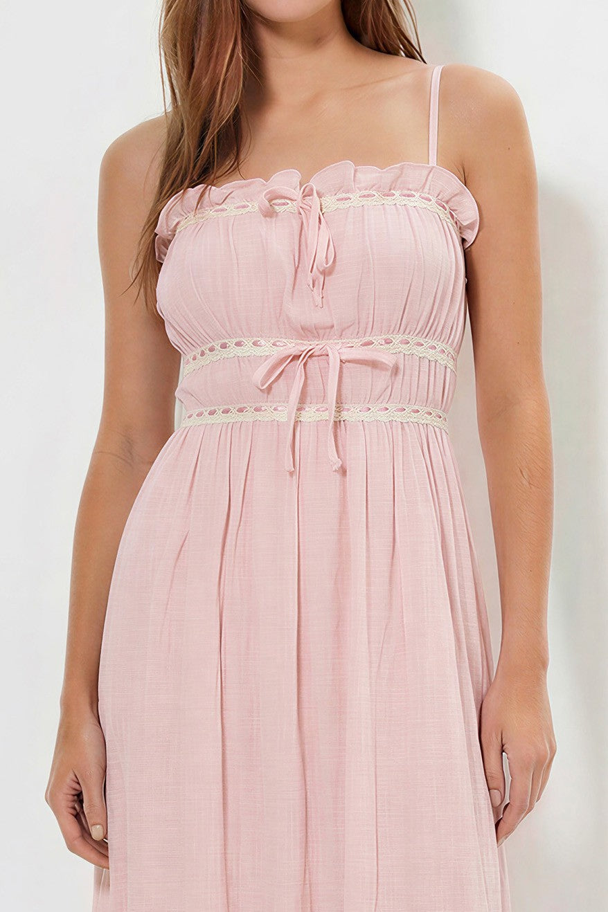 Blush spaghetti-strap ruffle-neckline crochet-lace-trim tie-front gathered-bodice ruffle-hem midi dress - close-up bodice detail showing fine spaghetti straps, gathered ruffle neckline frill, crochet lace trim band with centre-front bow tie, softly gathered pleated bodice, and crochet lace waistband with second bow tie in soft dusty blush pink