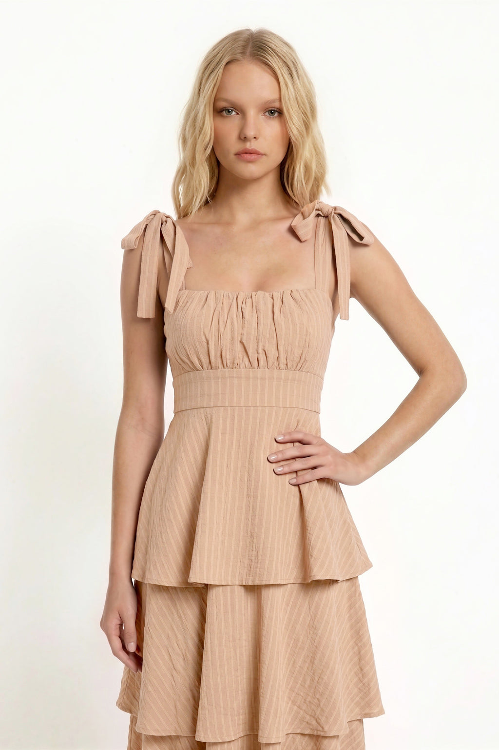 Black shoulder-tie-strap ruched-bust smocked-waist three-tier midi dress - back full-length view showing wide shoulder straps with tie bows, smocked back bodice, and full three-tier midi skirt from behind in deep black crinkle fabric