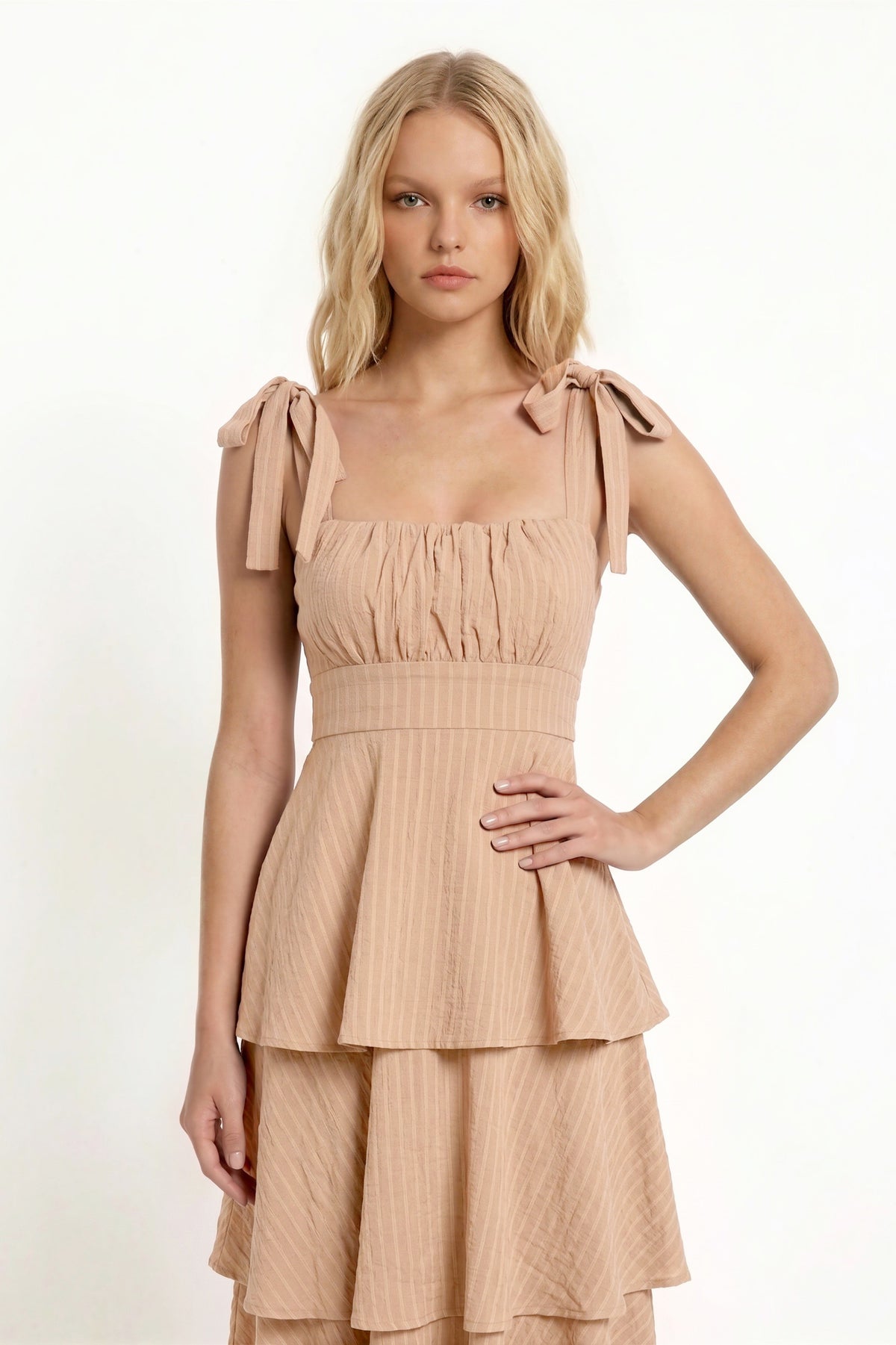 Black shoulder-tie-strap ruched-bust smocked-waist three-tier midi dress - back full-length view showing wide shoulder straps with tie bows, smocked back bodice, and full three-tier midi skirt from behind in deep black crinkle fabric