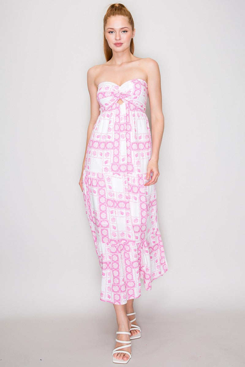 Pink seashell block-print strapless twist-front keyhole-cutout open-back tiered maxi dress - front full view showing strapless bodice, centre-front twist knot, keyhole cutout, seashell print, and full tiered maxi skirt