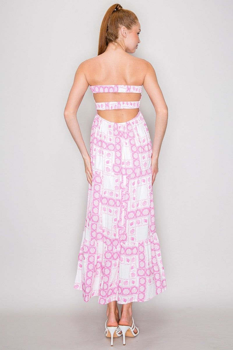 Pink seashell block-print strapless twist-front keyhole-cutout open-back tiered maxi dress - back full view showing open-back horizontal strap detail, wide open-back window, seashell print, and full tiered maxi skirt from behind