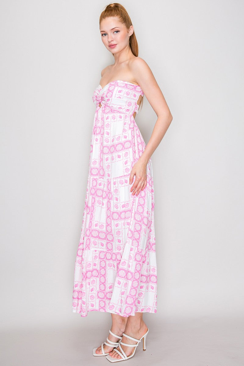 Pink seashell block-print strapless twist-front keyhole-cutout open-back tiered maxi dress - side full view showing strapless profile, twist-front bodice, full tiered skirt silhouette, and maxi length