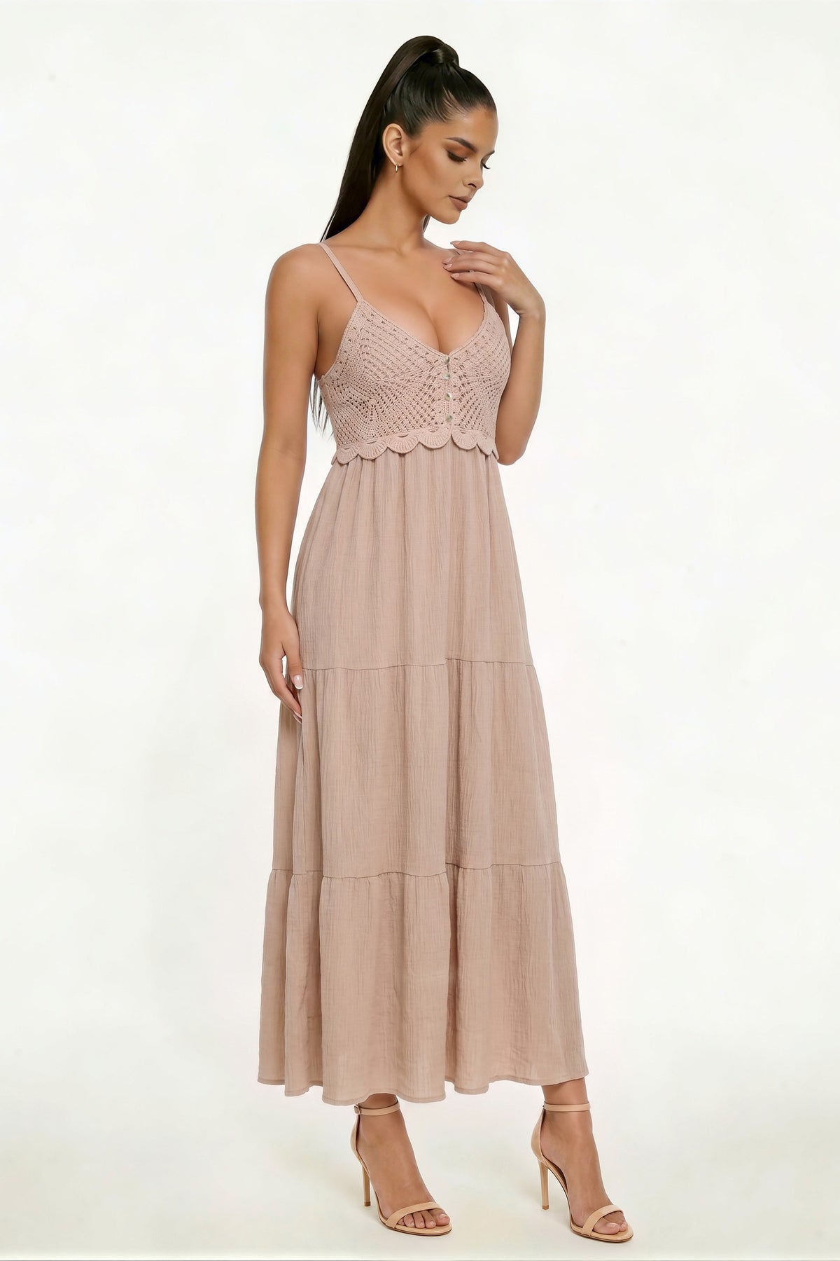 Taupe spaghetti-strap deep-V crochet-bodice button-front scallop-hem smocked-back tiered maxi dress - side three-quarter view showing fine spaghetti straps, deep-V crochet bodice profile with scallop hem, and full two-tier crinkle maxi skirt silhouette from the side in warm taupe-rose