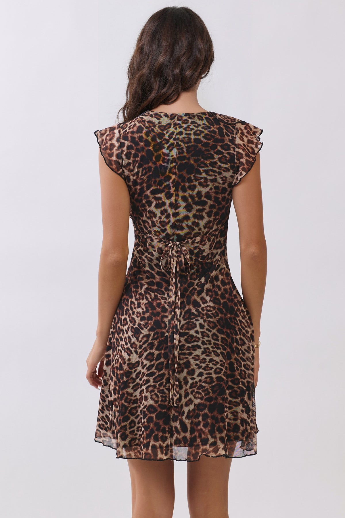 Leopard-print chiffon deep-V ruffle-sleeve back-tie fit-and-flare mini dress - back view showing open back neckline, centre-back self-tie bow, and ruffle cap sleeves