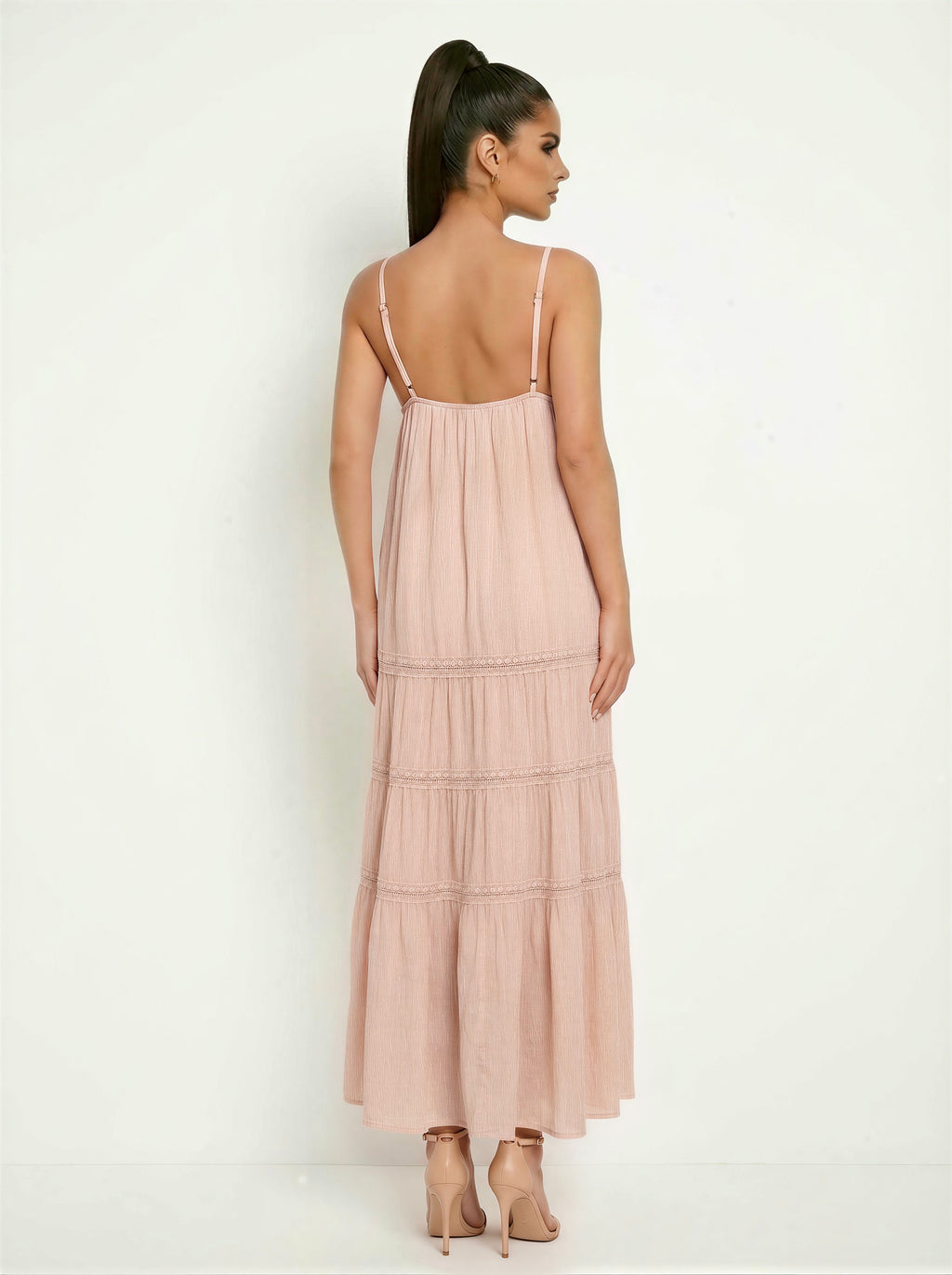 Blush spaghetti-strap deep-V lace-trim empire-waist tiered maxi dress - front three-quarter angled view showing deep-V neckline, lace bodice bands, empire waist, and full tiered maxi skirt with lace tier seam trim in soft dusty blush