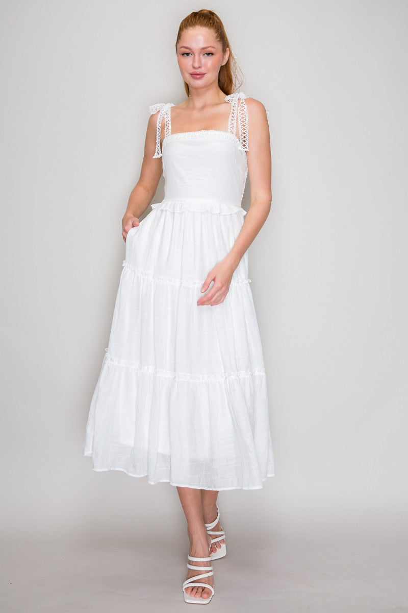 White square-neck smocked-bodice crochet-lace-strap tie-bow tiered midi dress - front full view showing clean square neckline, wide crochet lace straps with bow ties at shoulders, fully smocked bodice, double ruffle waist accent, and generous tiered midi skirt in crisp white