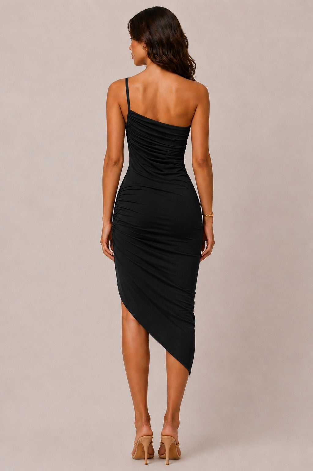 Black one-shoulder spaghetti-strap asymmetric-hem allover-ruched bodycon midi dress - back full view showing single spaghetti strap at back, open one-shoulder back detail, continuous ruched bodycon back silhouette, and asymmetric hem from behind in black