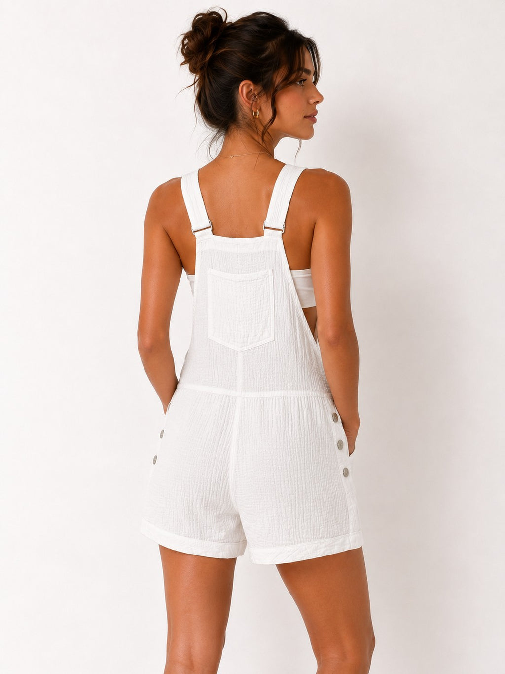 White crinkle-texture adjustable-strap bib-front side-cutout button-detail cuffed-short overall romper - front view showing bib pocket and overall silhouette
