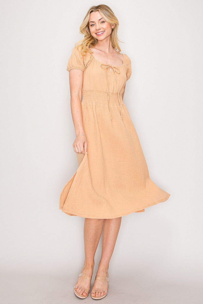 Peach crinkle-woven sweetheart-neck front-tie puff-sleeve smocked-waist fit-and-flare midi dress - front full view showing sweetheart neckline, tie bow, and full skirt