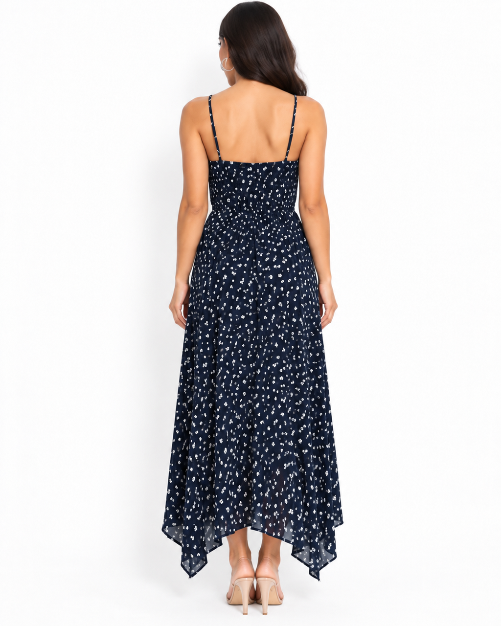 Navy ditsy-floral spaghetti-strap smocked-back handkerchief-hem midi dress - back white background view showing fine adjustable spaghetti straps with metal hardware, fully smocked back bodice, and voluminous flowing handkerchief-hem skirt from behind in deep navy with white ditsy florals