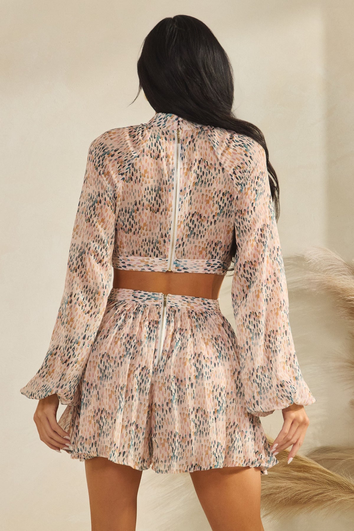Blush pink abstract-print high-neck front-keyhole balloon-sleeve side-cutout pleated mini dress - front full view showing high neck, keyhole, and balloon sleeves