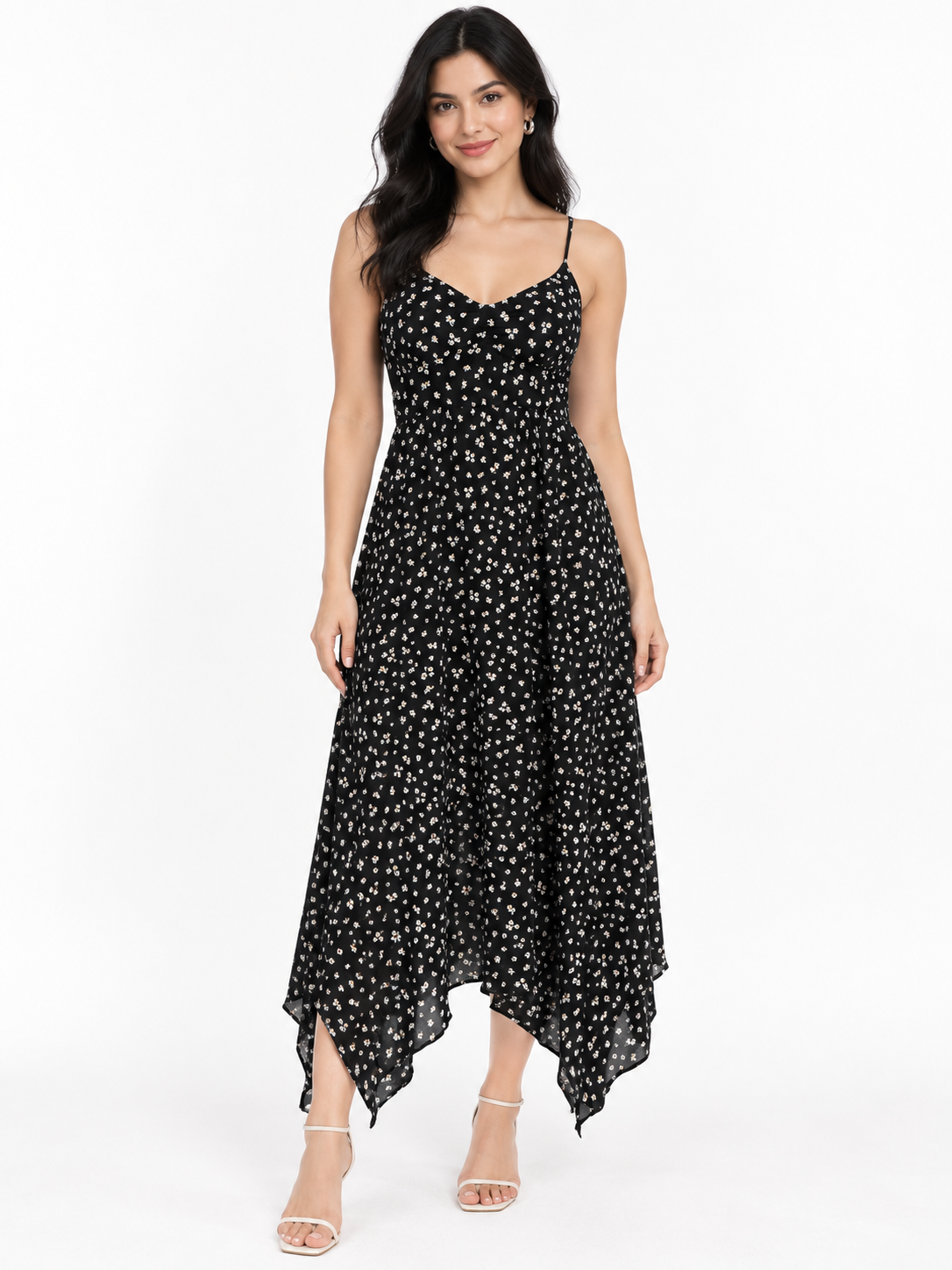 Black ditsy-floral spaghetti-strap smocked-back handkerchief-hem midi dress - back white background view showing fine adjustable spaghetti straps, fully smocked back bodice, and voluminous flowing handkerchief-hem skirt in black with white ditsy florals