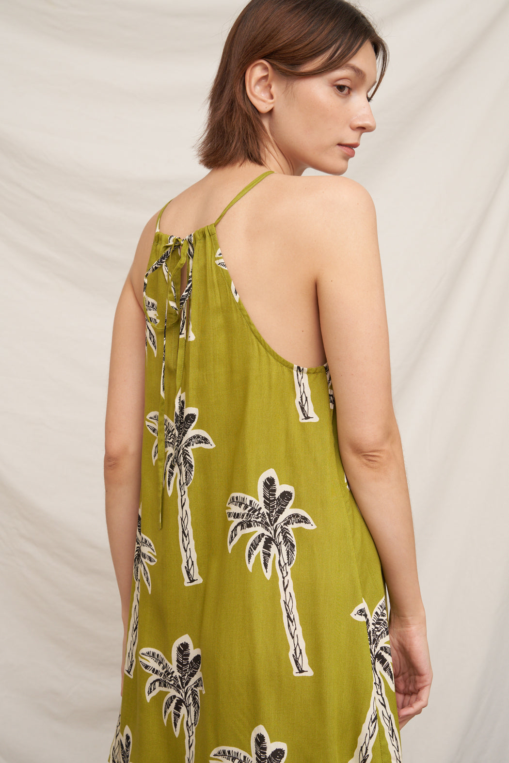 Olive green palm tree print halter neck swing mini dress - back open view