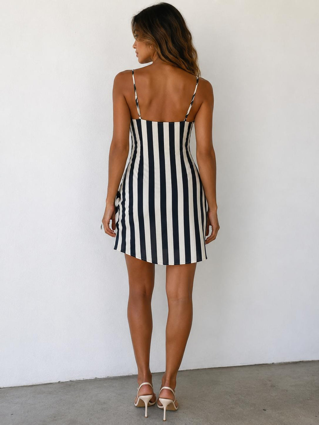 Black and white stripe spaghetti-strap cowl-neck side-ruche asymmetric-hem mini dress - side view two showing stripe chevron effect at skirt