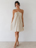 Cream polka dot halter gathered-bust smocked-back open-back babydoll mini dress - back view showing fully open back and smocked waistband