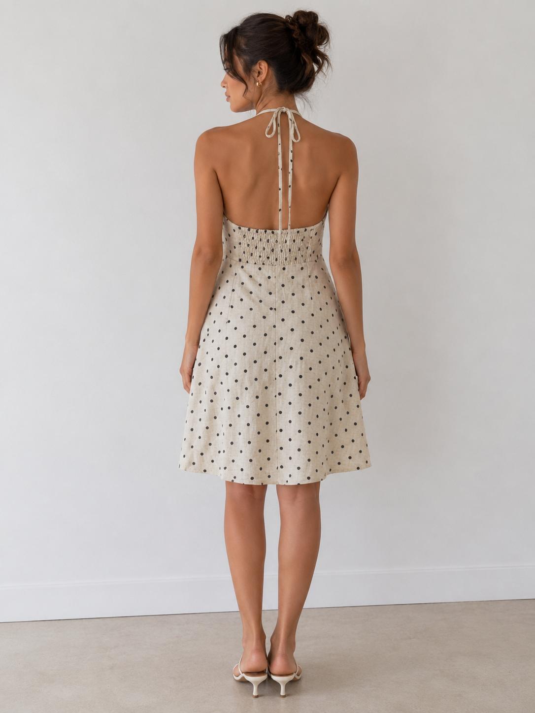 Cream polka dot halter gathered-bust smocked-back open-back babydoll mini dress - side view two showing open back and halter tie