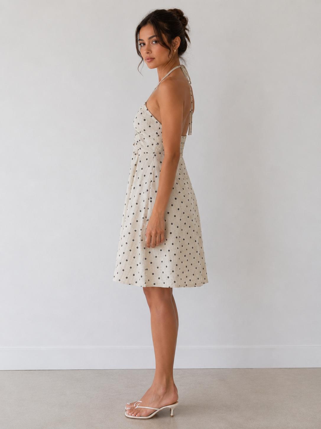 Cream polka dot halter gathered-bust smocked-back open-back babydoll mini dress - side view one showing babydoll silhouette