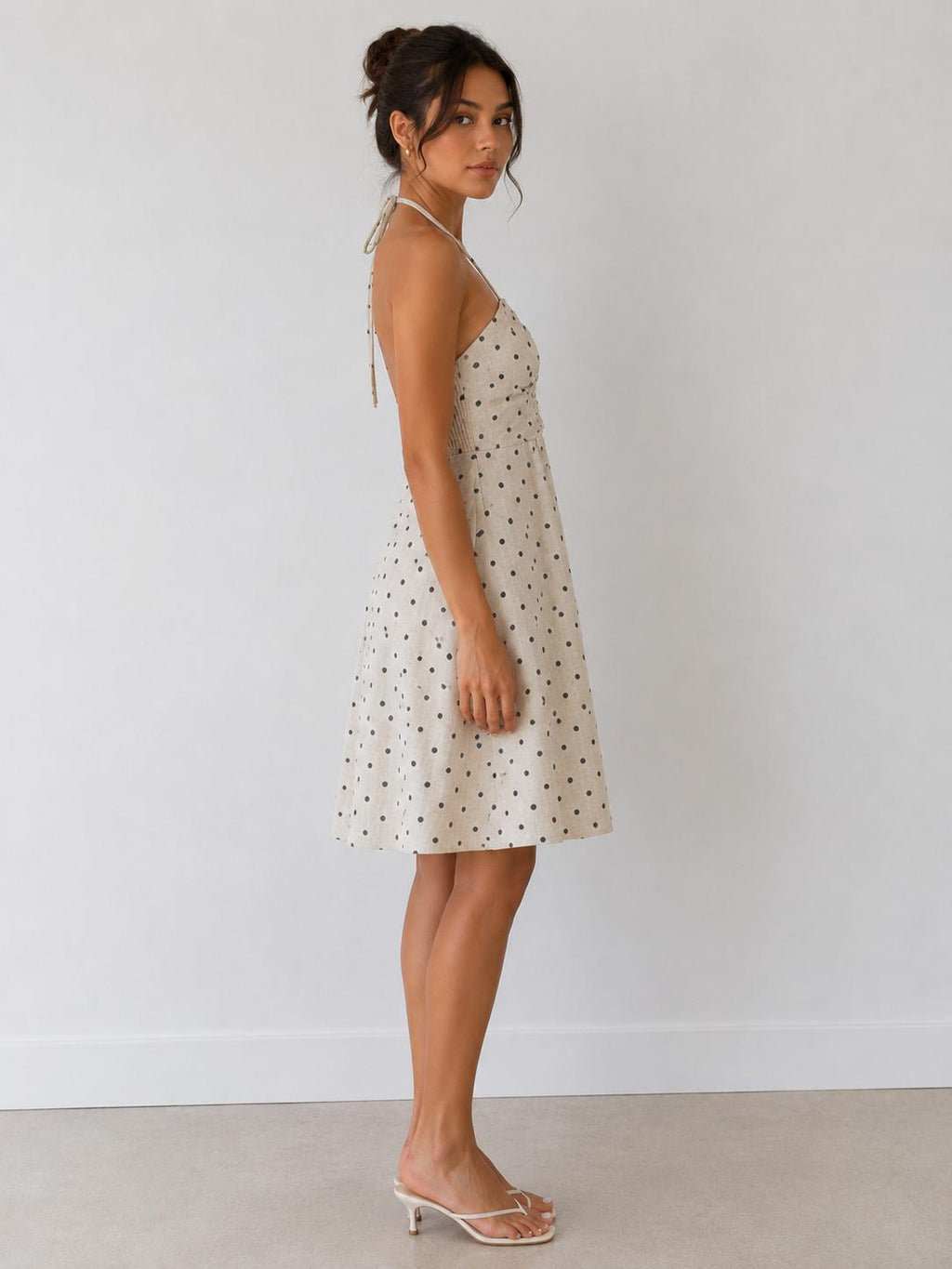 Cream polka dot halter gathered-bust smocked-back open-back babydoll mini dress - front full view showing gathered bust and halter straps