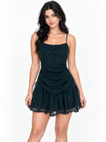 Emerald green glitter-mesh spaghetti-strap cowl-scoop ruched-body drop-waist double-ruffle-hem mini dress - front full-length view showing spaghetti straps, cowl scoop neckline, densely ruched glitter mesh body, drop waist, and voluminous double-ruffle mini skirt in deep teal-emerald green