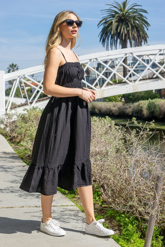 Red spaghetti-strap ruffle-trim smocked-bodice tiered midi dress - front full-length view showing fine spaghetti straps, delicate ruffle neckline trim, fully smocked bodice, and full tiered A-line midi skirt in bold vivid red