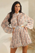 Blush pink abstract-print high-neck front-keyhole balloon-sleeve side-cutout pleated mini dress - three-quarter front view showing side cutout and pleated skirt