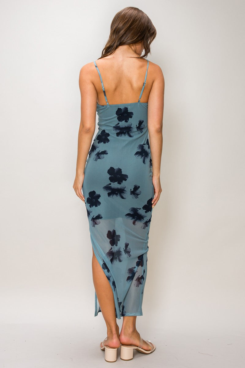 Slate blue floral print triple O-ring cut-out spaghetti-strap bodycon midi dress - back full view showing fine spaghetti straps, smooth open back, bodycon silhouette from behind, side slit at midi hem, and large-scale dark navy floral print on slate blue from behind