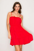 Cherry red ruffle trim tie-front smocked waist tiered mini dress - front view